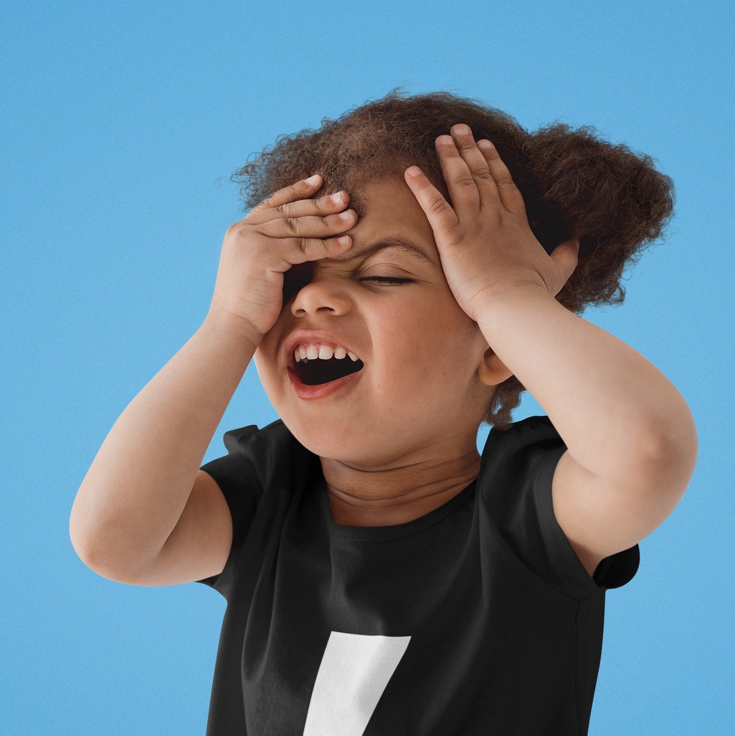 Child wearing a black t-shirt with a white lightning bolt design against a blue background