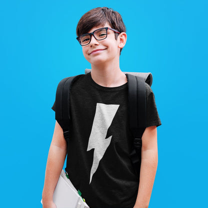 Young boy wearing a black t-shirt with a white lightning bolt design and glasses, standing against a blue background.